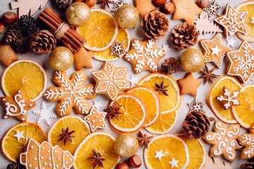 Christmas background, winter holidays, New Year party, celebration concept. Texture with homemade gingerbread cookies, dried orange slices and spices on stone table, greeting card template
