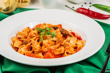 Tagliatelle pasta with seafood. Close up, Decorated with lemon, basil, shrimps, mussels, cheese, pepper