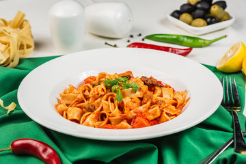 Tagliatelle pasta with seafood. Close up, Decorated with lemon, basil, shrimps, mussels, cheese, pepper