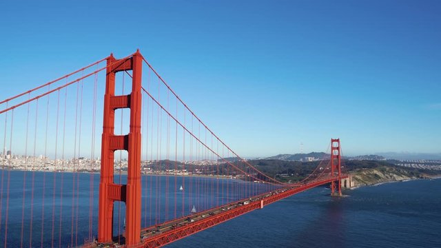 Golden Gate Bridge San Francisco California USA. iron red connection building with mountain in city urban summer nature blue sky. busy cars traffic driving cross ocean sea water beautiful view.