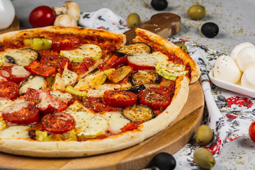 Vegetarian Pizza made with zucchini, mozzarella, pepper, eggplant and tomato.