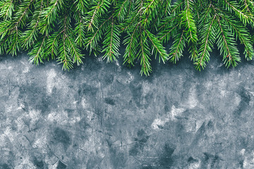 Christmas and New Year background with  fir branches in a dark style. Copy space and top view.