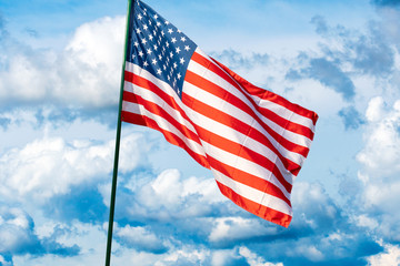 Flag of the USA against the cloudy sky