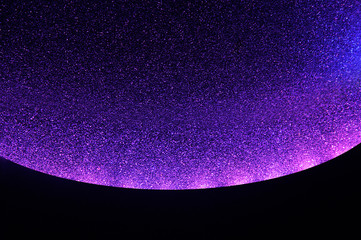 Blurred texture of glitter's paper. Festive background.