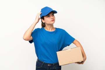 Young delivery girl over isolated white background having doubts and with confuse face expression