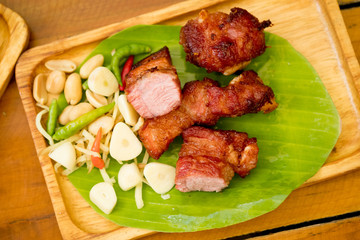 Fried pork rib served with side dish of garlic, chilli and nut