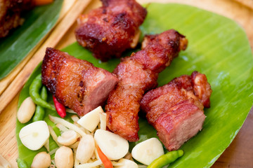 Fried pork rib served with side dish of garlic, chilli and nut