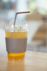 Plastic glass of tea lemonade with straw
