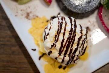 Vanilla ice cream with chocolate sauce topping