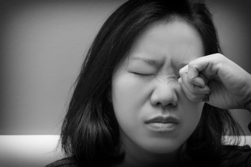 Asian woman rubbing her eye. Concept of  eye's problem, dust allergy, dry eye, watery, itching or...