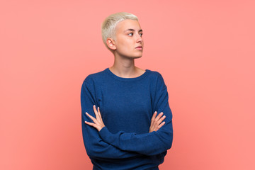 Teenager girl with white short hair over pink wall portrait