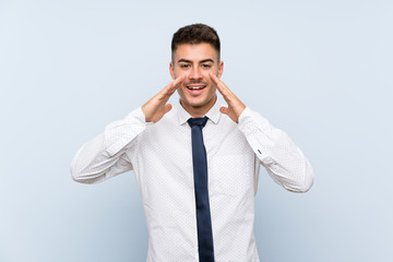 Handsome businessman over isolated blue background shouting with mouth wide open