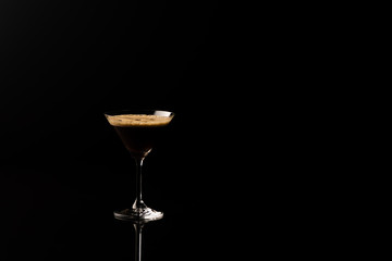 Espresso Martini. Coffee Cocktail, maked with vodka, espresso, liqueur. On a black background space for text