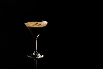 Espresso Martini. Coffee Cocktail, maked with vodka, espresso, liqueur. On a black background space for text