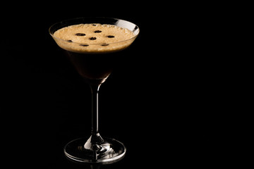 Espresso Martini. Coffee Cocktail, maked with vodka, espresso, liqueur. On a black background space for text