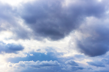 Naklejka na ściany i meble white formidable clouds against a gloomy sky on a cloudy summer day