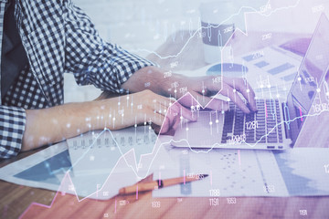 Fototapeta premium Multi exposure of stock market chart with man working on computer on background. Concept of financial analysis.