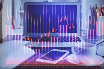 Financial chart drawing and table with computer on background. Double exposure. Concept of international markets.