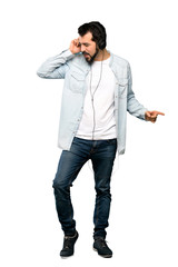 Fototapeta premium Handsome man with beard listening music