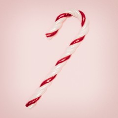 3D illustration. Red and white candy stick on a pale pink background with left copy space
