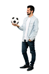 Fototapeta premium Handsome man with beard holding a soccer ball