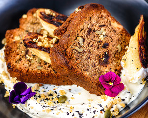 Two slices of Banana Bread on a bed of Tahini Yoghurt with grilled bananas