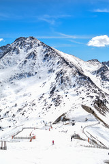 View of slopes in popular ski resort pas de la casa in the Pyrenees mountains, Andorra. Skiers going downhill -Image