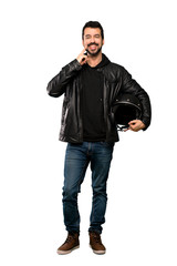 Full-length shot of Biker man smiling with a happy and pleasant expression over isolated white background