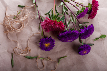 cut violet and pink asters are collected in a bouquet