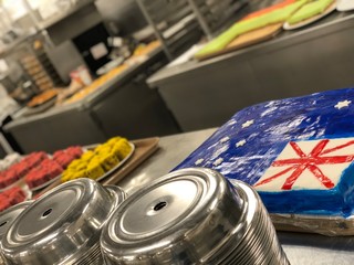Big selection of cakes on the table. Big galley on the cruise ship kitchen, pastry section. Cake...