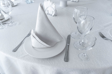 Served banquet table with empty dishes.