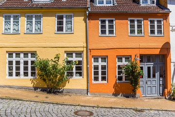 Fototapeta na wymiar Orange and yellow house in historic city Flensburg, Germany