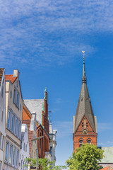 Fototapeta na wymiar Church tower and historic facades in Flensburg, Germany