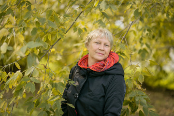 Portrait of a beautiful middle-aged woman outdoors. Selective focus.