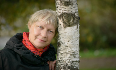 Portrait of a beautiful middle-aged woman outdoors. Selective focus.