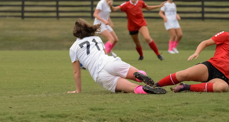 Obraz premium Teenage Girl Tackles During Soccer Game