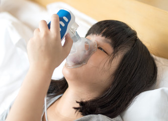 Pediatric health kid concept. Asia sick child with inhaler nebulizer to treat illness of Asthma...