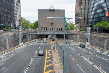 Fototapeta na wymiar USA, New York - May 2019: USA, Rear of Hugh.L Carey Tunnel Ventilation Building and highway entrance,exit