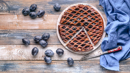 Food banner: Homemade delicious pie with prunes on a rustic background.