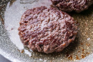 Close-up two appetizing juicy burger on a ceramic pan.