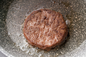 Vegetable cutlet for a vegetarian hamburger in a ceramic pan. Horizontal shot