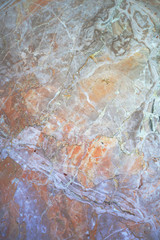 polished light orange veined stone surface, photo