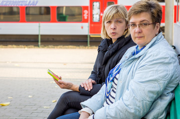 Two Mature women chatting waiting for a train
