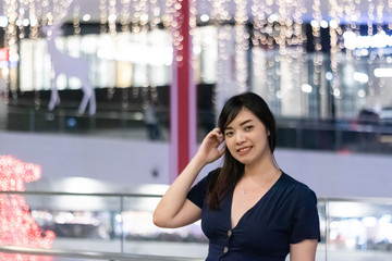Beautiful Asian woman smiling with bokeh background.