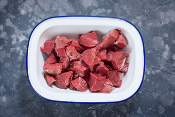 Raw sliced beef heart in enameled shape, top view, selective focus