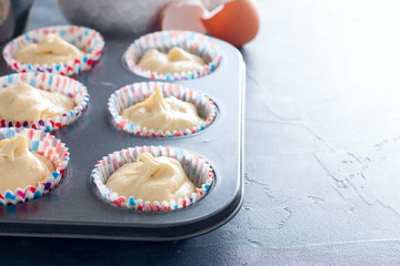 Raw cupcake dough in a cupcake baking dish, horizontal, copy space