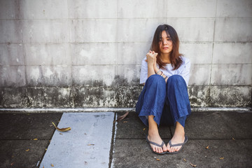 Young Asian girl sitting on the stressed and feeling depressed.