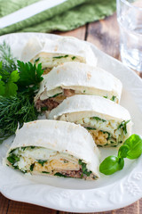 Lavash roll with canned saury, cheese and eggs, selective focus
