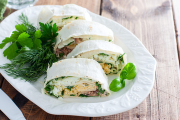 Lavash roll with canned saury, cheese and eggs, selective focus
