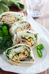 Lavash roll with canned saury, cheese and eggs, selective focus